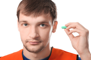 Wall Mural - Male worker with earplug on white background. Hearing protection equipment