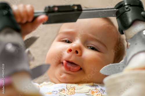 Fotografie, Obraz Happy Baby with Tongue Tie and Orthopedic Shoes