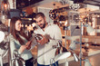 © JackF - Smiling couple customers choosing desk lamp