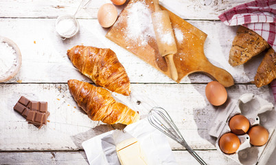 Wall Mural - Croissants and ingredients for the preparation of bakery products.