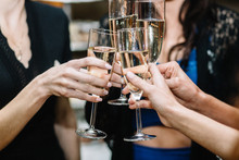 Group Of Partying Girls Clinking Flutes With Sparkling Wine