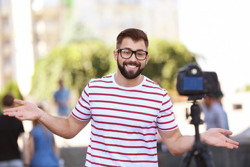 Young blogger recording video outdoors