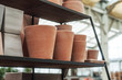 closeup of terra cotta pots pile in a green house