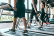 © PR Image Factory - Row of people exercising on treadmills