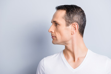 Portrait with copy space, empty place for product, advertisement of attractive, stylish man with turned profile face to the side, having perfect ideal oiled, dry skin, isolated on grey background