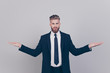 © deagreez - Handsome serious attractive expert experienced qualified leader brutal pensive confident concentrated man wearing black suit with white shirt demonstrating empty blank place isolated gray background