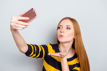 Close Up Portrait Of Charming Flirty Coquettish Romantic Excited Cheerful Chic Beautiful Long-haired Woman Taking Selfie Wearing Yellow Black Pullover Isolated On Gray Background