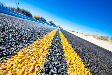 Yellow stripes on asphalt road