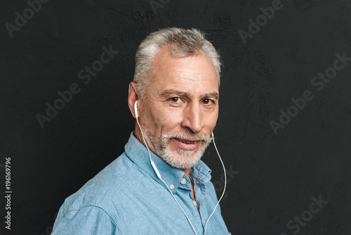 Portrait Of Handsome Mature Man 60s With Gray Hair Looking On