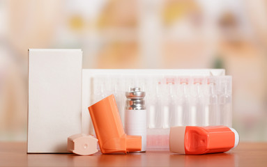 Two portable inhaler with dispenser and a box of ampoules on table