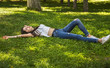 © osmanpek - relaxing girl lying on the grass.