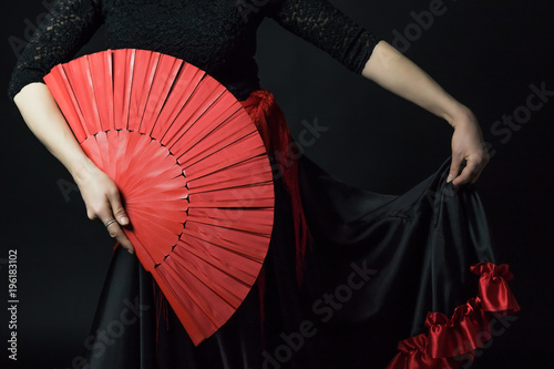 Low Key photo of Flamenco Dancer middle age woman holding red fan and her skirt Wallpaper Mural