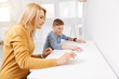 © zinkevych - Technological progress. Positive nice happy mother and daughter sitting together and using virtual technology while being at home