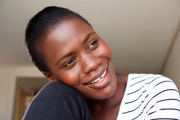 Wall Mural - Close up happy african woman sitting at home and smiling