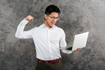 Wall Mural - Portrait of an angry young asian man dressed in shirt