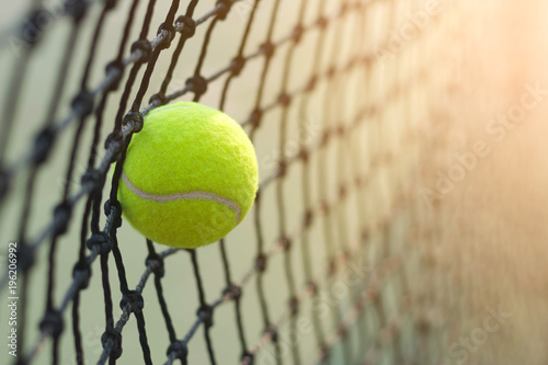 Fotomural Close up tennis ball hitting to net on blur background