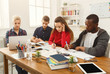 © Prostock-studio - Group of diverse students studying at wooden table