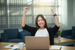 © reewungjunerr - Beautiful asian businesswoman working at the office  in the evening,Thailand worker happy after looking laptop,Success from work