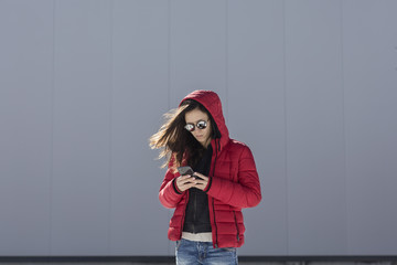 Portrait of a  young woman using her phone