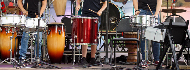 music, people, musical instruments and entertainment. musicians playing drums and cymbals at concert