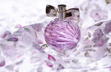 Female Purple Perfume On Light Background