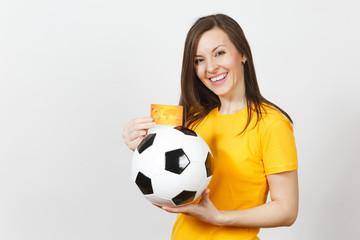 Wall Mural - Beautiful European young cheerful woman, football fan or player in yellow uniform holding credit card soccer ball isolated on white background. Sport, play football game, excitement lifestyle concept.