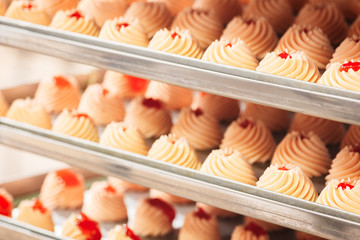 Poster - Сooking sweet pastry, sweet confectionery biscuits on metallic shelf of rack, production line. food concept  background