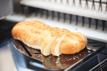 Aufkleber - Fresh sliced white bread on breadslicer machine