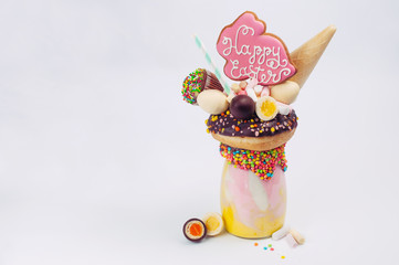 Wall Mural - Easter freak shake decorated with Easter bunny gingerbread on light background