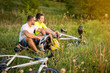 © sergo321 - cyclists husband and wife sit on top and look at the sunset in summer
