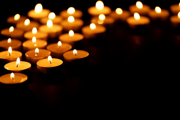 Burning candles on black background