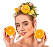 Hair mask from fresh fruits on woman head. Girl with beautiful face hold ingredient for homemade organic skin and hair therapy. Improvement of skin condition.