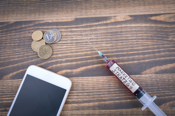 Wall Mural - marketing strategy concept. Medicine syringe with liquid inside and inscribtion.
