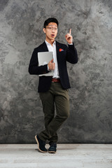 Poster - Full length portrait of an excited young asian man