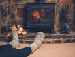 © LoloStock - Feet of young woman by fire