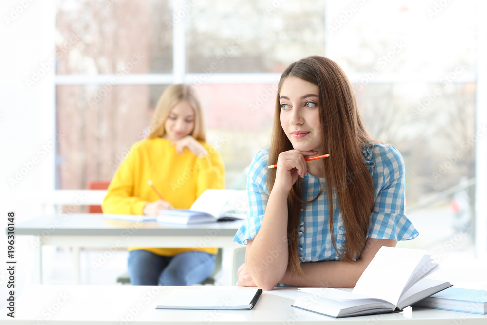 Female student preparing for exam in library