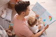 © Africa Studio - Father with little daughter reading bedtime story at home