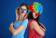 © Africa Studio - Young women in funny disguise posing on color background. April fool's day celebration