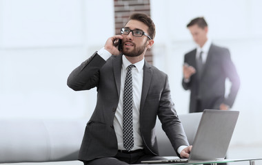 Sticker - Confident young man talking on phone in office