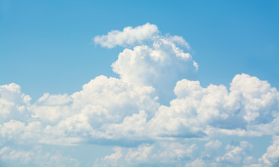 Wall Mural - white curly clouds in a blue sky. sky background