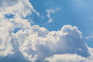 Wall Mural - white curly clouds in a blue sky. sky background