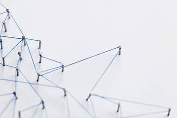 Poster - A large grid of pins connected with string. Communication, technology, network concept