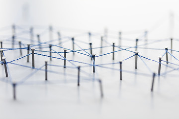 Poster - A large grid of pins connected with string. Communication, technology, network concept