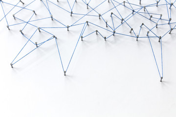 Poster - A large grid of pins connected with string. Communication, technology, network concept