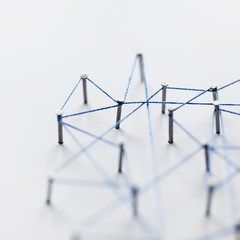 Poster - A large grid of pins connected with string. Communication, technology, network concept
