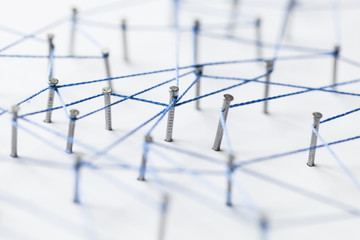 Poster - A large grid of pins connected with string. Communication, technology, network concept