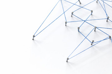 Poster - A large grid of pins connected with string. Communication, technology, network concept