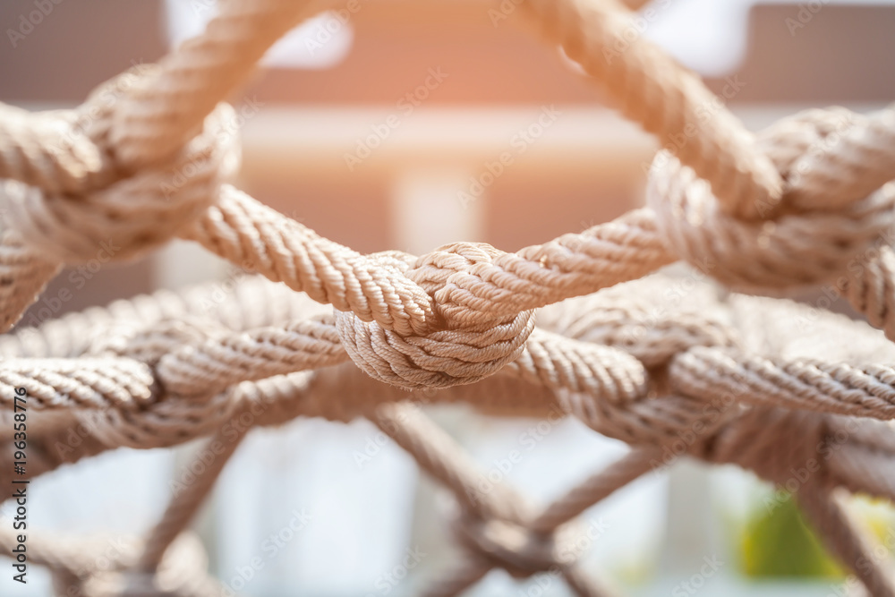 Close-up of rope knot line tied together with playground background.selective focus. - obrazy, fototapety, plakaty 