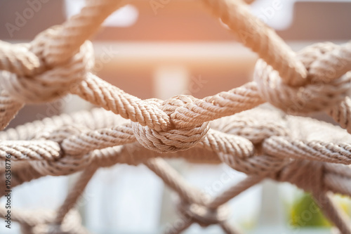 Fotomural Close-up of rope knot line tied together with playground background