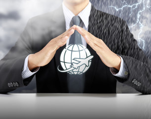 businessman hand protect plan with storm background, safety and insurance